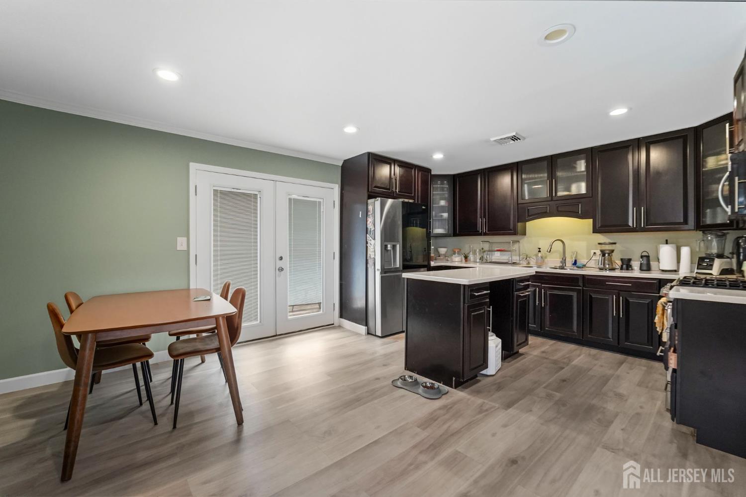 122 3rd Street Middlesex, NJ 08846 - Photo 7 of 24 a kitchen with kitchen island granite countertop wooden floors and stainless steel appliances