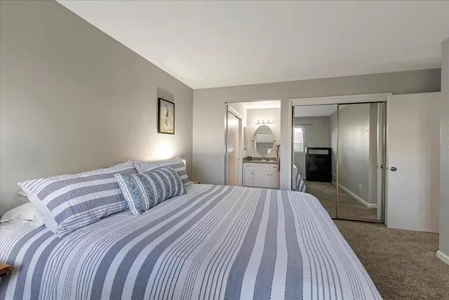 a bedroom with a bed and a walk in closet