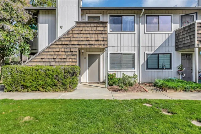 a front view of a house with a garden