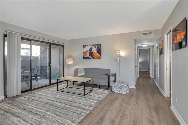 a spacious bedroom with a bed and a chandelier