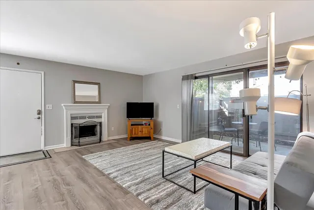 a living room with furniture a fireplace and a flat screen tv