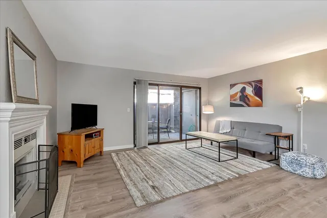 a living room with furniture a fireplace and a flat screen tv