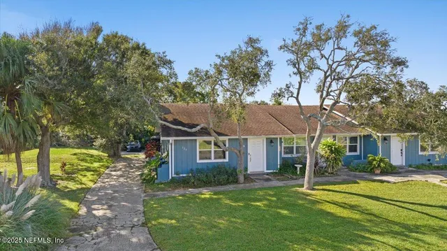 a front view of a house with a yard table and chairs