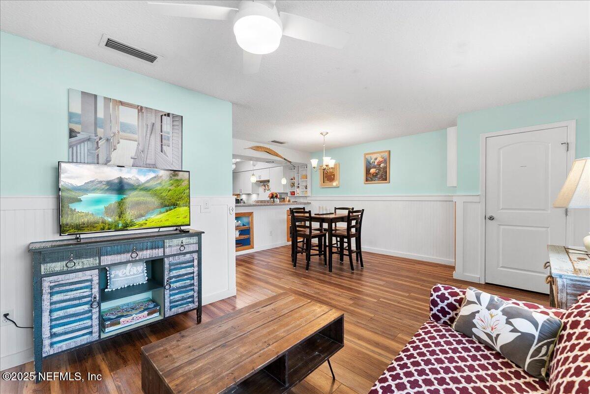 125 Rio Del Mar Street, Unit A St. Augustine, FL 32080 - Photo 11 of 30 a living room with furniture and a flat screen tv