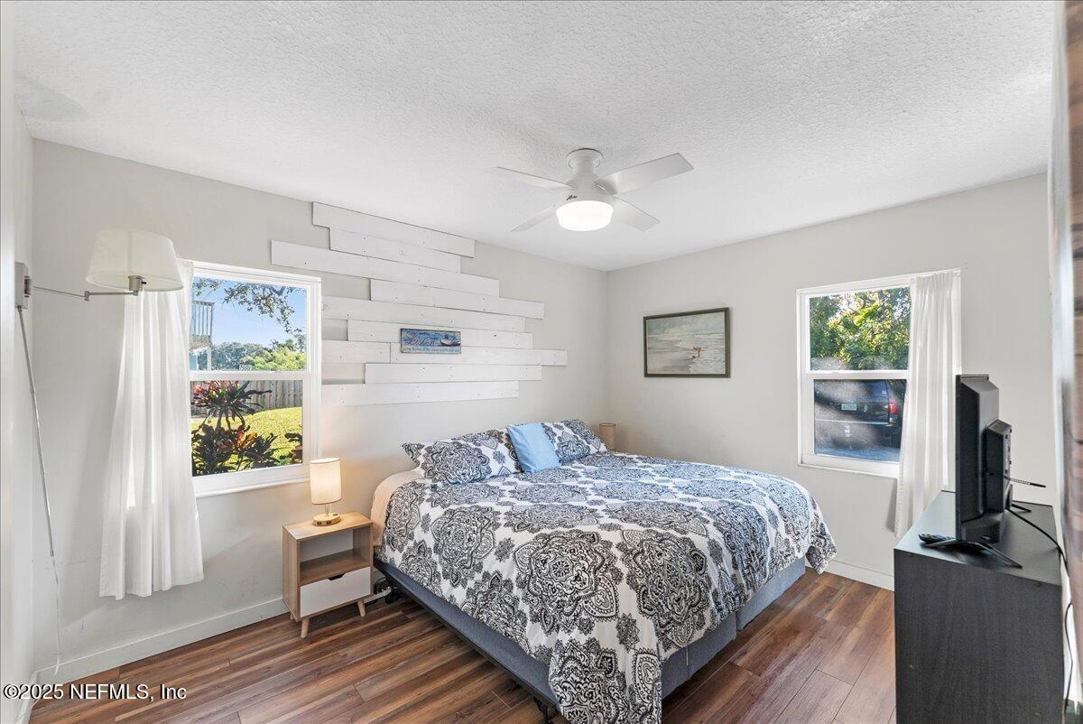 125 Rio Del Mar Street, Unit A St. Augustine, FL 32080 - Photo 14 of 30 a bedroom with a bed table and a window