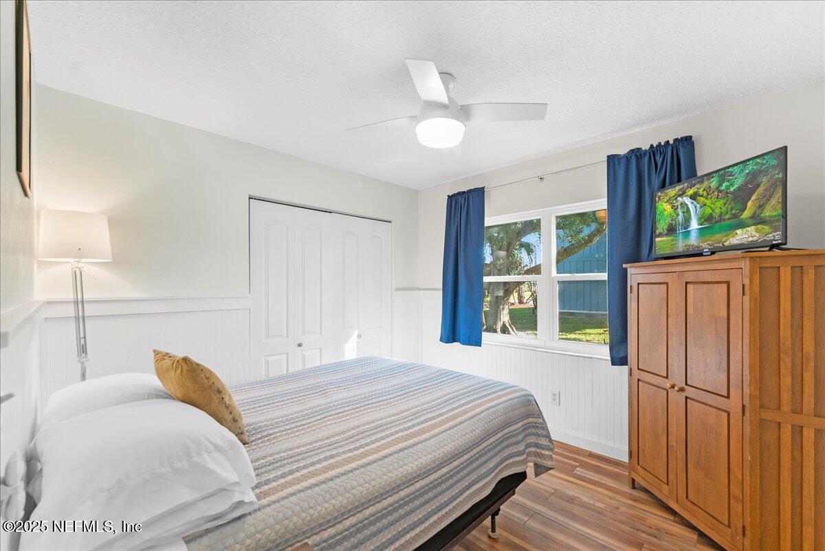 125 Rio Del Mar Street, Unit A St. Augustine, FL 32080 - Photo 17 of 30 a bedroom with a large bed and a flat tv screen on dresser