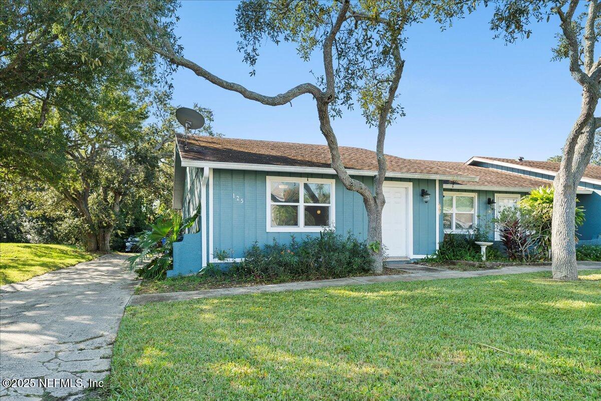 125 Rio Del Mar Street, Unit A St. Augustine, FL 32080 - Photo 18 of 30 a front view of a house with garden