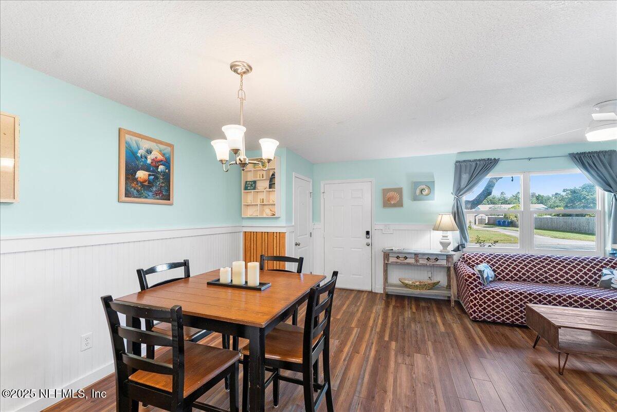 125 Rio Del Mar Street, Unit A St. Augustine, FL 32080 - Photo 9 of 30 a dining room with furniture and wooden floor