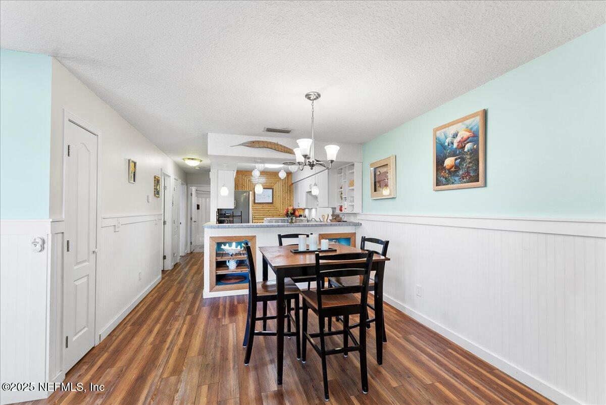 125 Rio Del Mar Street, Unit A St. Augustine, FL 32080 - Photo 10 of 30 a view of a dining room with furniture and wooden floor
