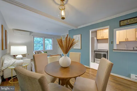 a dining room with furniture a window and a chandelier