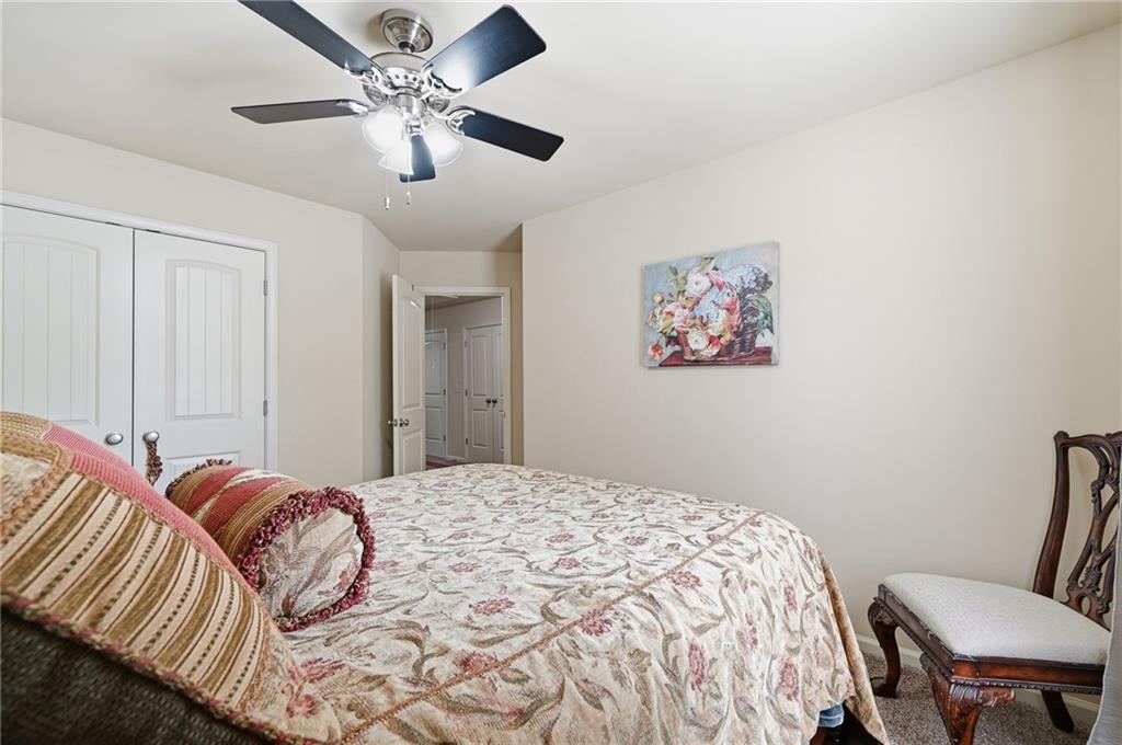 608 Myers Gate Road Ball Ground, GA 30107 - Photo 23 of 31 a bedroom with a bed and a chair