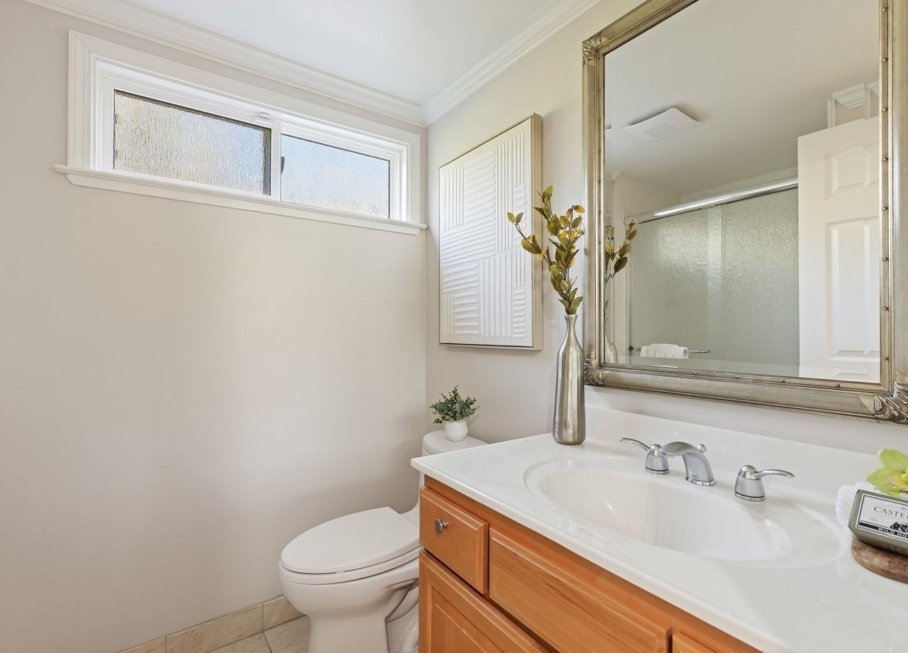 2632 Campeche Court San Ramon, CA 94583 - Photo 33 of 43 a bathroom with a granite countertop sink a toilet and mirror