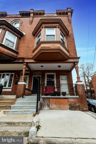 a view of a house with large windows and a white roof