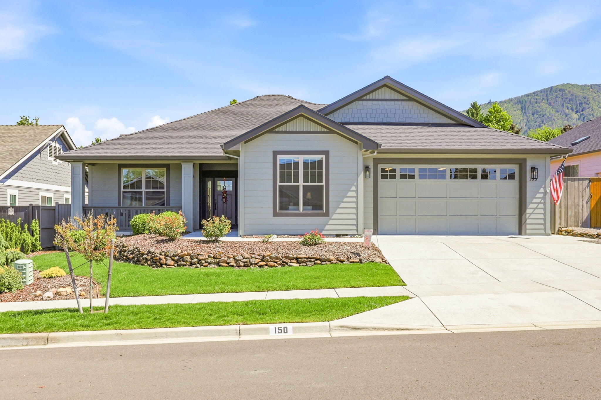 150 Timbers Lane Talent, OR 97540 - Photo 1 of 39 a front view of a house with a garden and yard