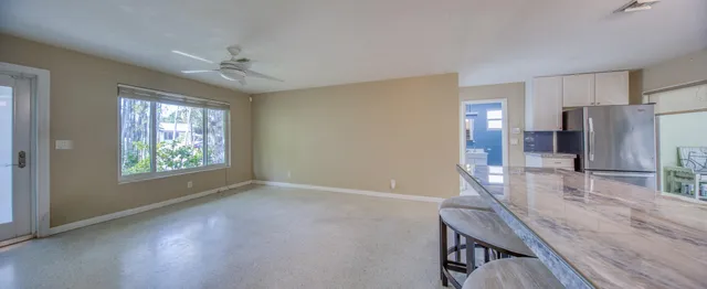 a kitchen with windows and refrigerator