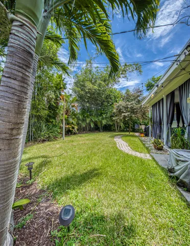a view of a backyard with plants and a patio