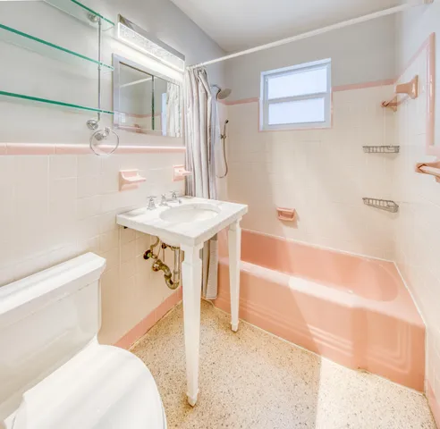 a bathroom with a sink a toilet and a bathtub