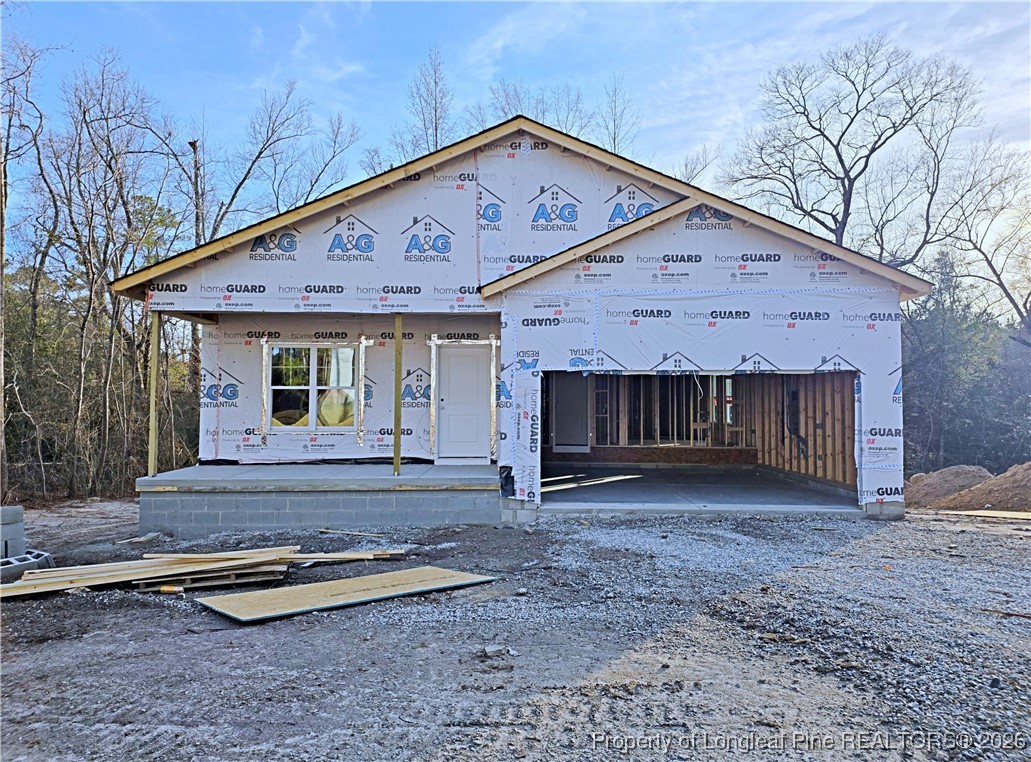 a view of a house with backyard and wooden fence