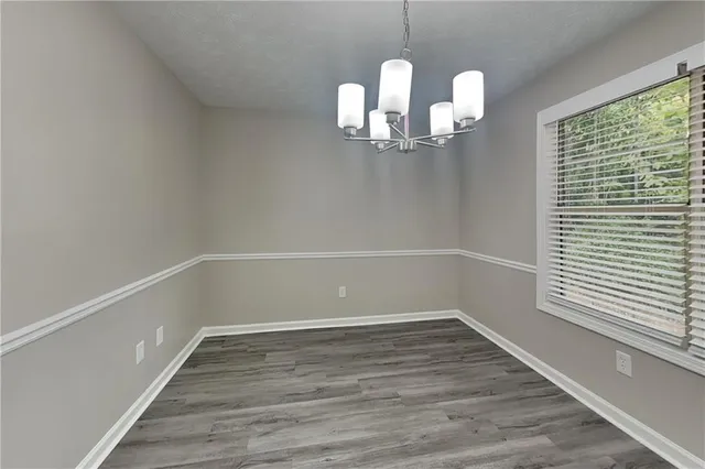 a view of a room with wooden floor and windows