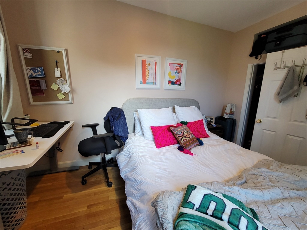11 Phillips Street, Unit 8 Boston, MA 02114 - Photo 8 of 14 a bedroom with a bed and wooden floor