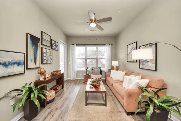 a patio with a table and chairs and potted plants