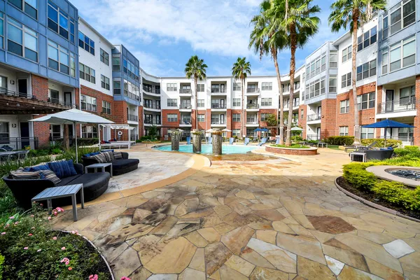 a living room with furniture ceiling fan and a window