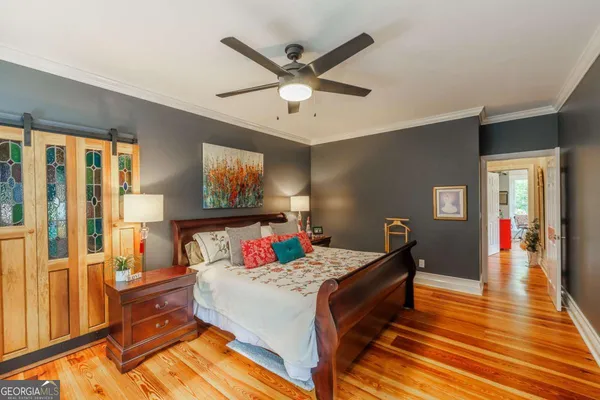 a bedroom with a bed and a chandelier