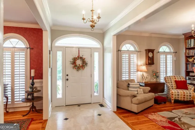 a view of a dining room with furniture and a chandelier