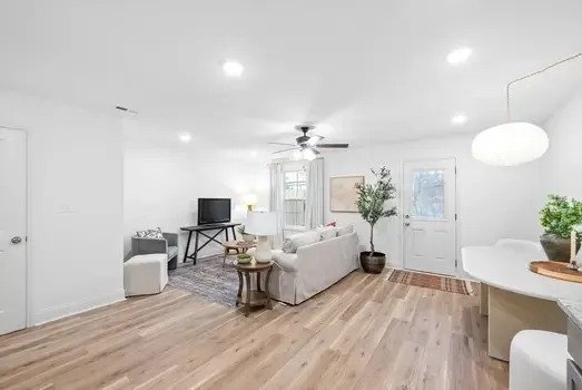 a kitchen with white cabinets stainless steel appliances and a refrigerator