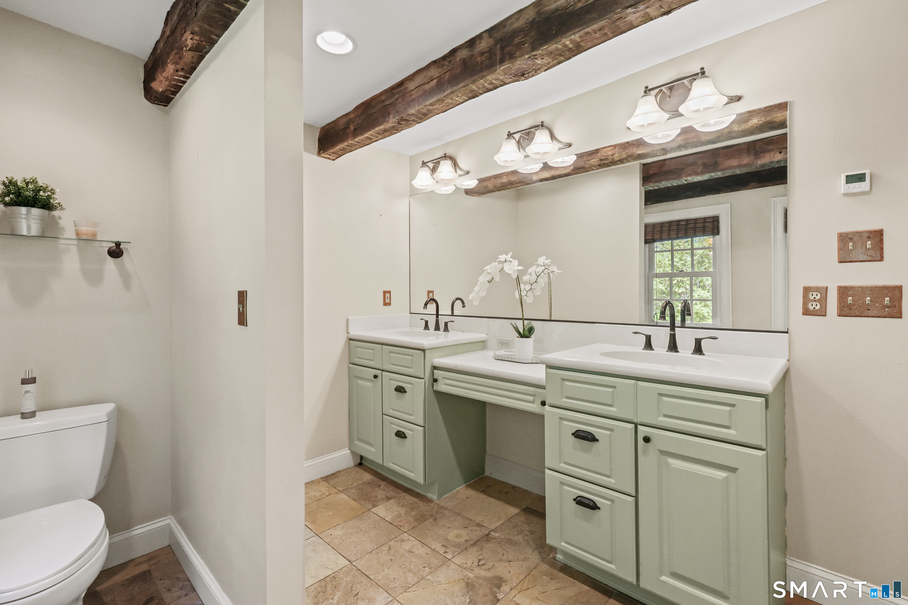2880 Main Street Coventry, CT 06238 - Photo 27 of 40 Renovated upper level full bathroom with double sink vanity, exposed beams, & radiant heated tile flooring.