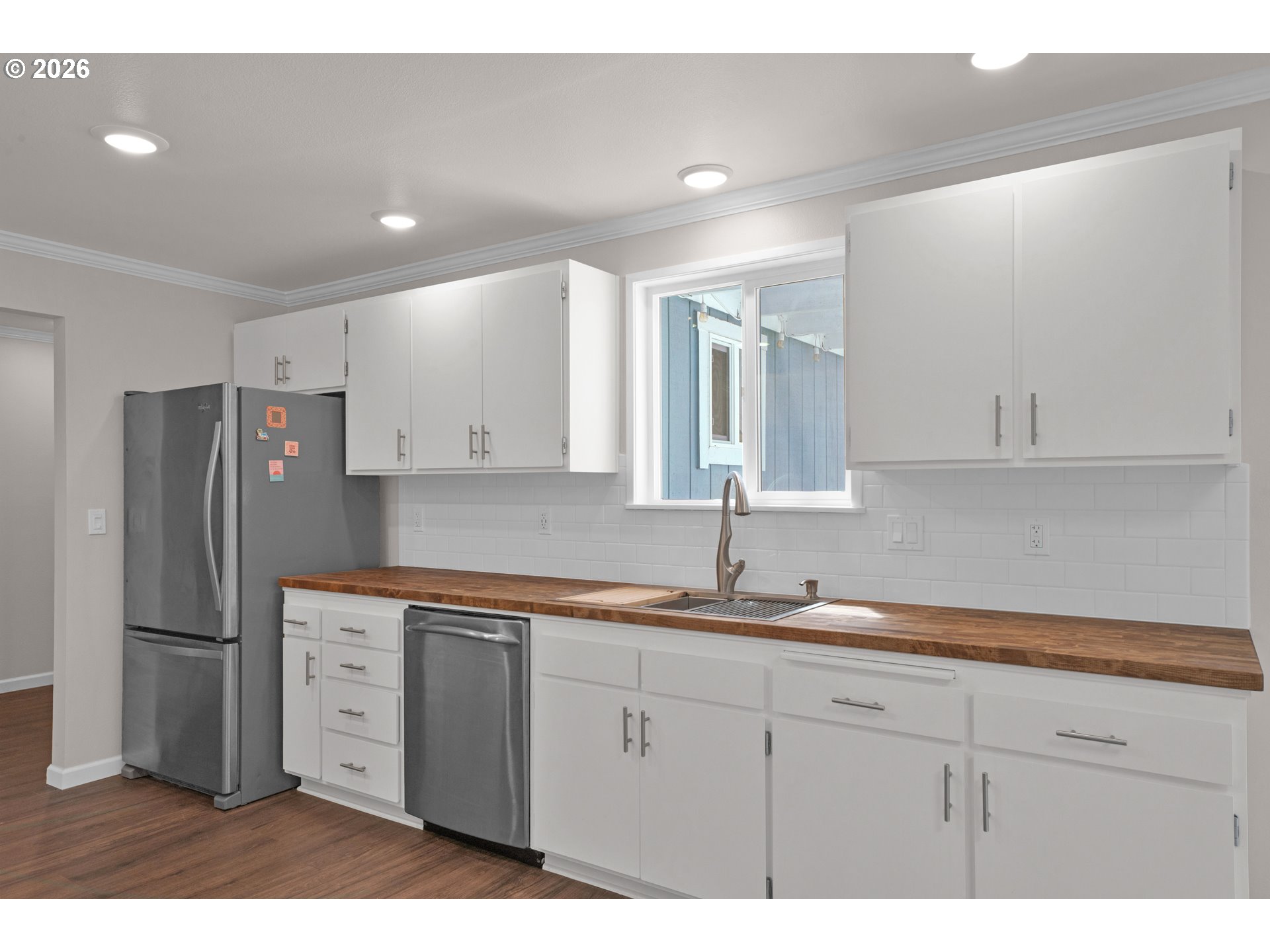 1142 9th Street Florence, OR 97439 - Photo 13 of 41 a kitchen with a sink dishwasher a refrigerator and cabinets