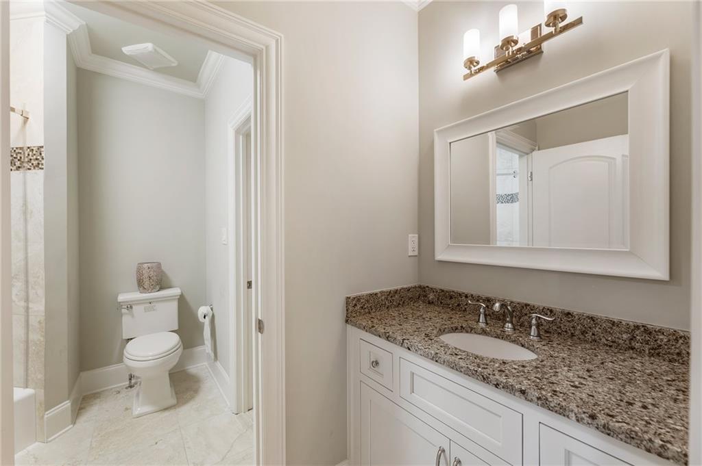 14560 Wood Road Milton, GA 30004 - Photo 46 of 74 a bathroom with a granite countertop sink and a mirror