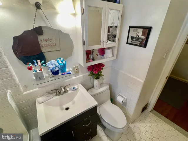 a bathroom with a sink mirror and toilet