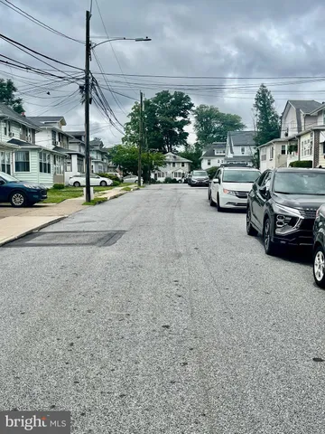 a view of a city street with a car parked on the road
