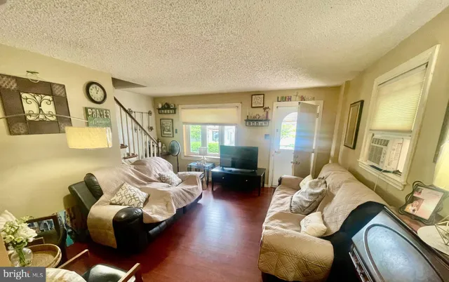 a living room with furniture fireplace and a large window