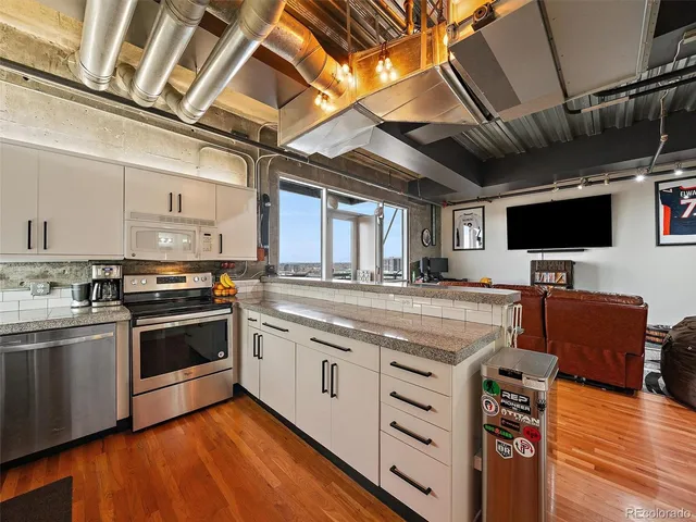a kitchen with stainless steel appliances granite countertop a stove and a sink with cabinets