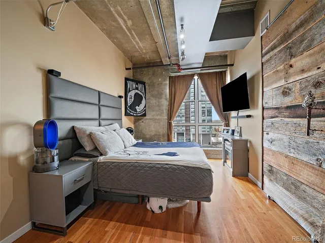 a bed room with a bed and a television