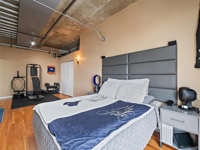 a bed room with a bed and gym equipment