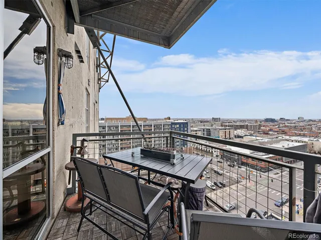 a view of a balcony with furniture and wooden floor