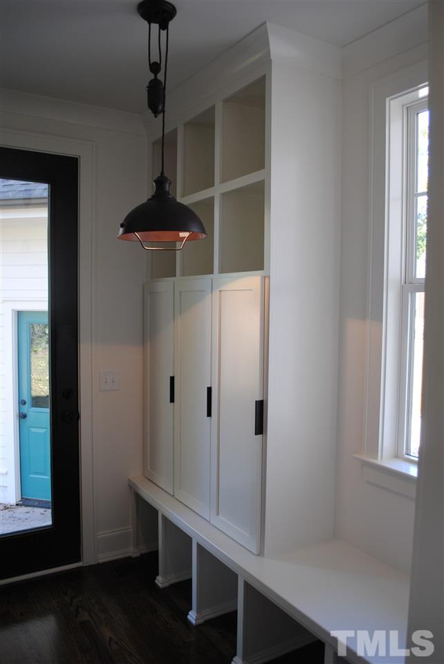 106 Revival Way Raleigh, NC 27608 - Photo 14 of 25 a room with a window and a chandelier
