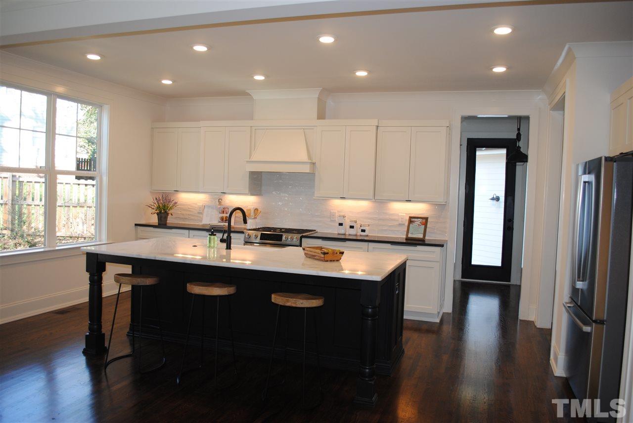 106 Revival Way Raleigh, NC 27608 - Photo 3 of 25 a kitchen with granite countertop a sink appliances and cabinets
