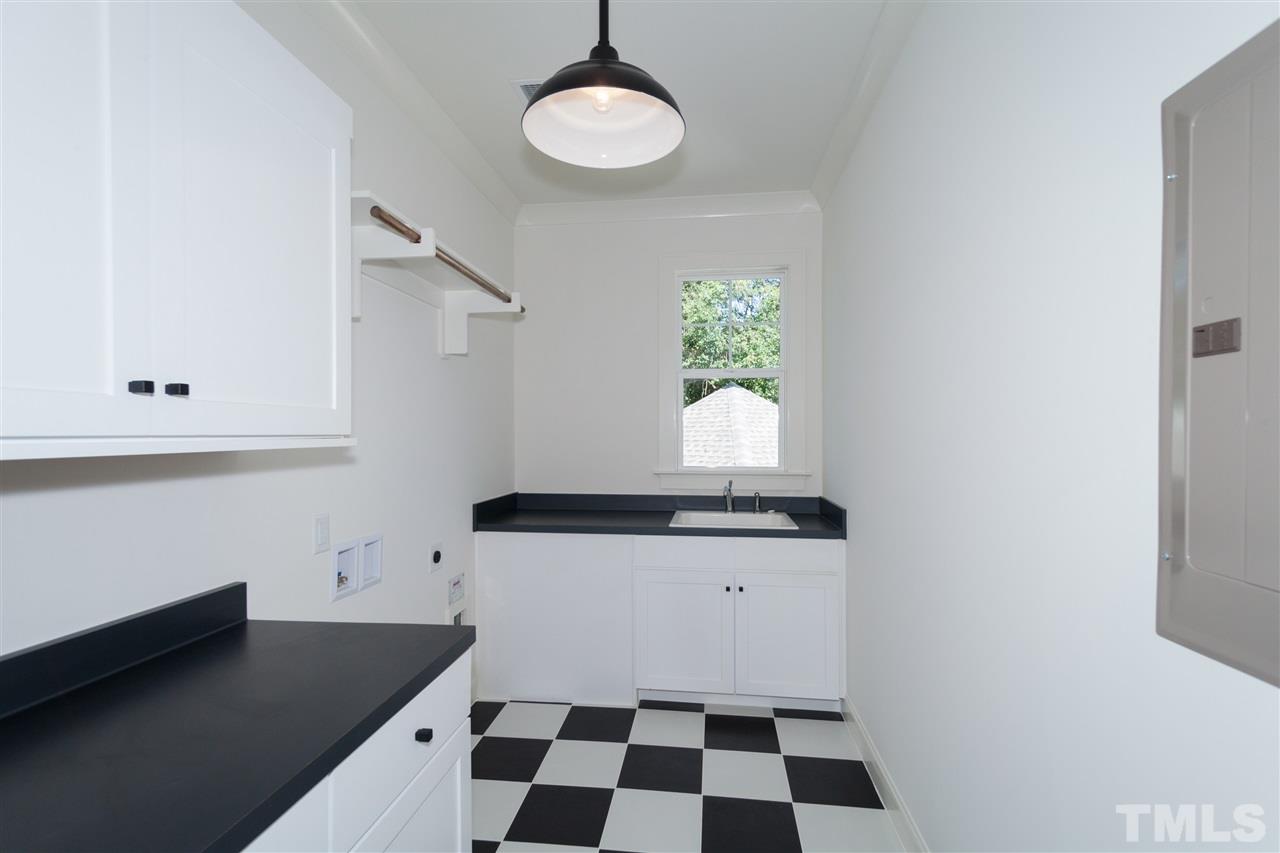 106 Revival Way Raleigh, NC 27608 - Photo 22 of 25 a kitchen with granite countertop a stove a sink and a microwave