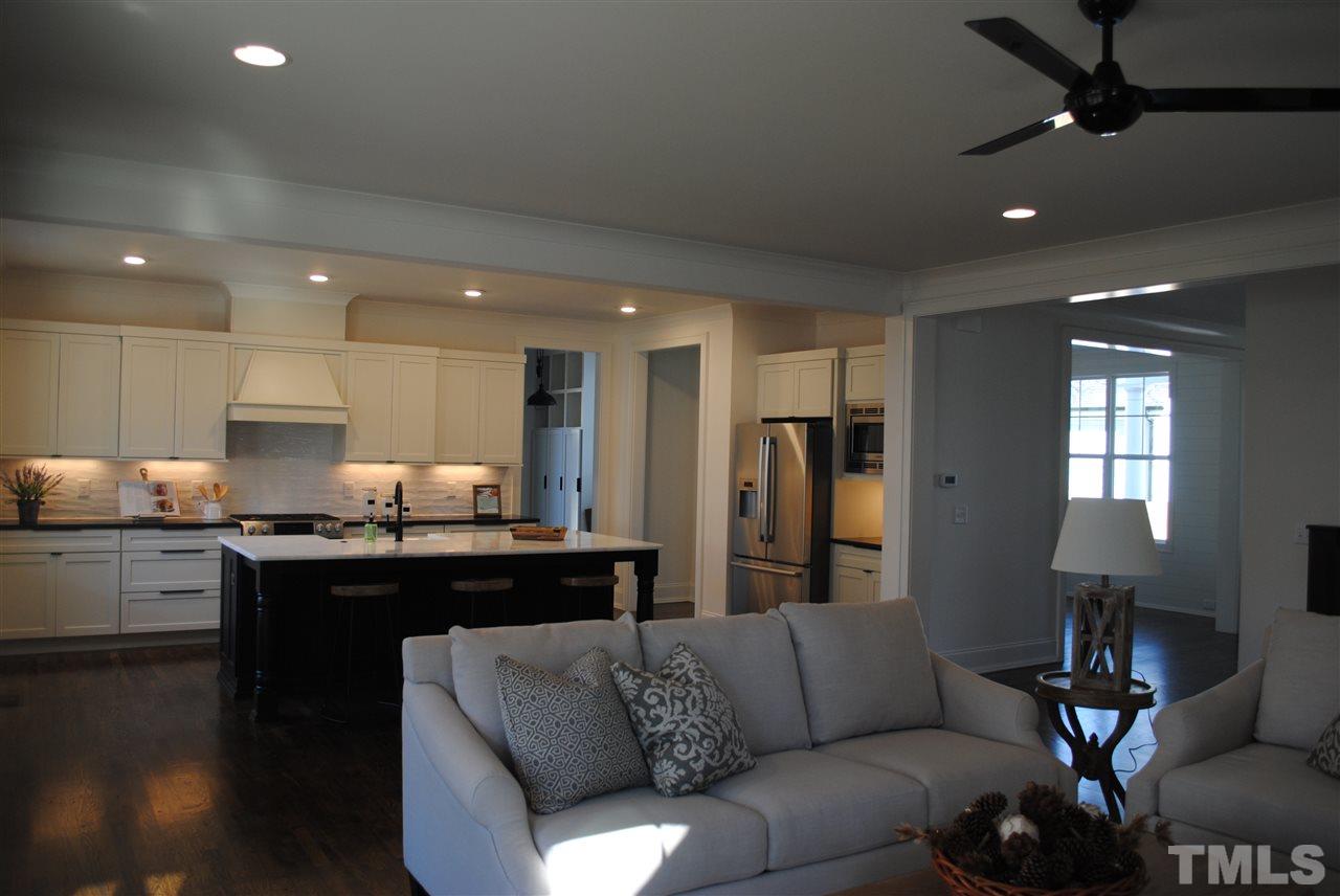 106 Revival Way Raleigh, NC 27608 - Photo 7 of 25 a view of kitchen with kitchen island stainless steel appliances sink stove dining table and chairs