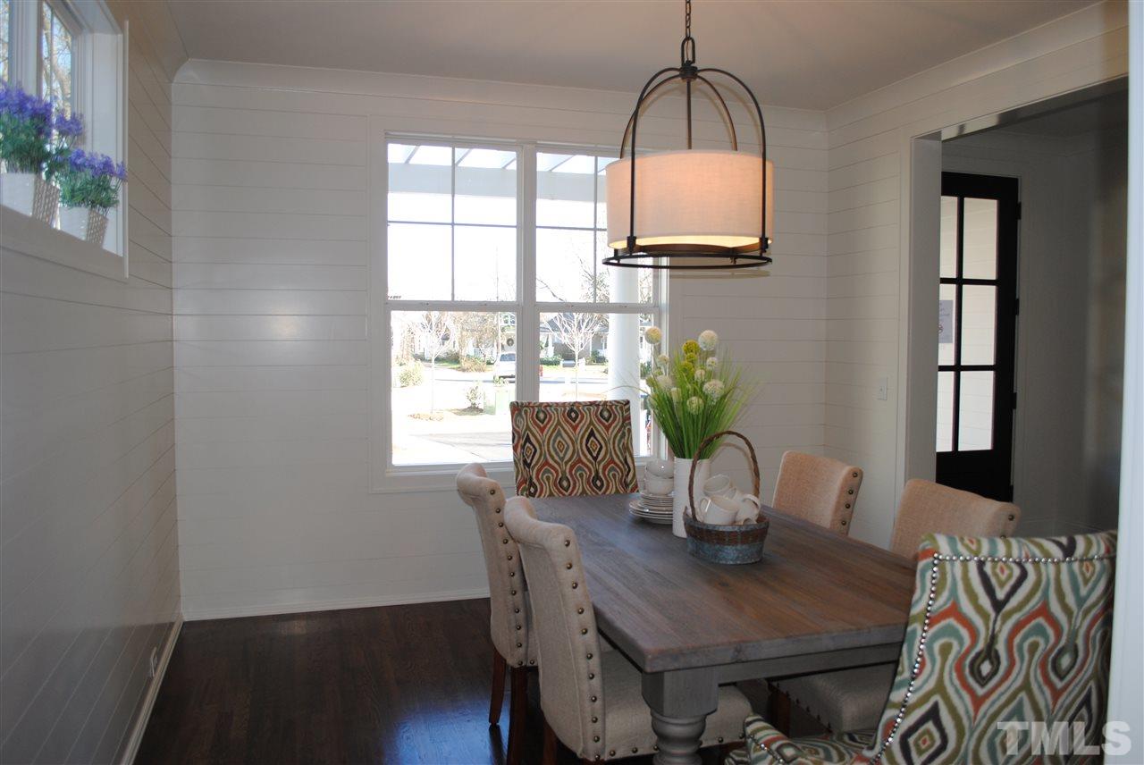 106 Revival Way Raleigh, NC 27608 - Photo 10 of 25 a dining room with furniture and wooden floor