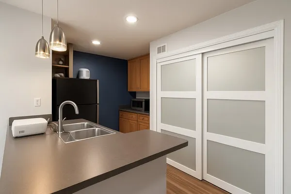 a kitchen with a refrigerator and a sink
