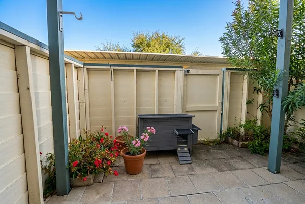 a view of a porch with furniture and plants