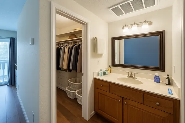 a bathroom with a sink vanity and mirror