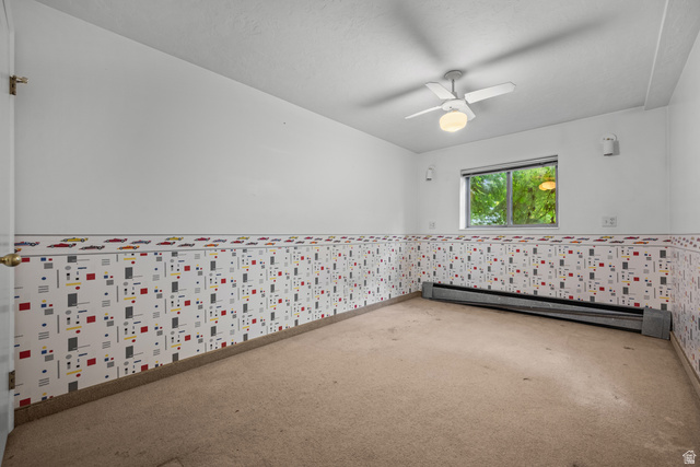 328 Heather Ridge Circle Sandy, UT 84070 - Photo 16 of 28 Room featuring a ceiling fan with integrated lighting, a window with exterior foliage visible, and baseboard heating