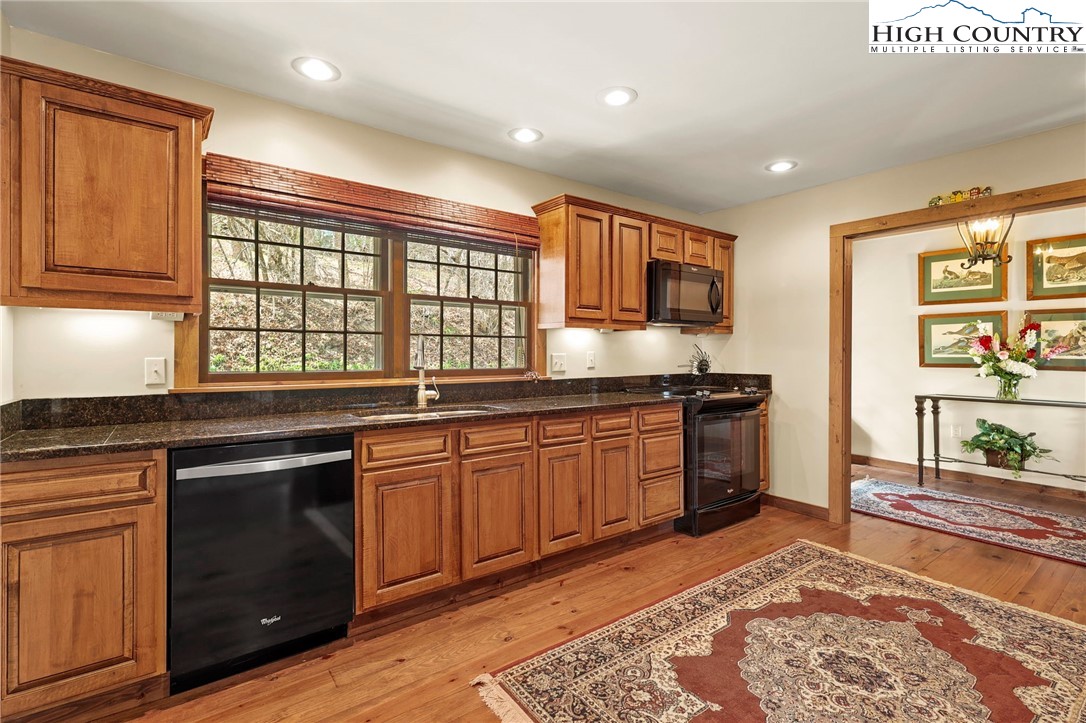 8015 Cloud Forest Lane Blowing Rock, NC 28605 - Photo 11 of 23 a kitchen with stainless steel appliances granite countertop a stove a sink and a microwave