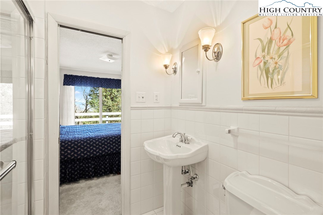 8015 Cloud Forest Lane Blowing Rock, NC 28605 - Photo 15 of 23 a bathroom with a sink a toilet and shower